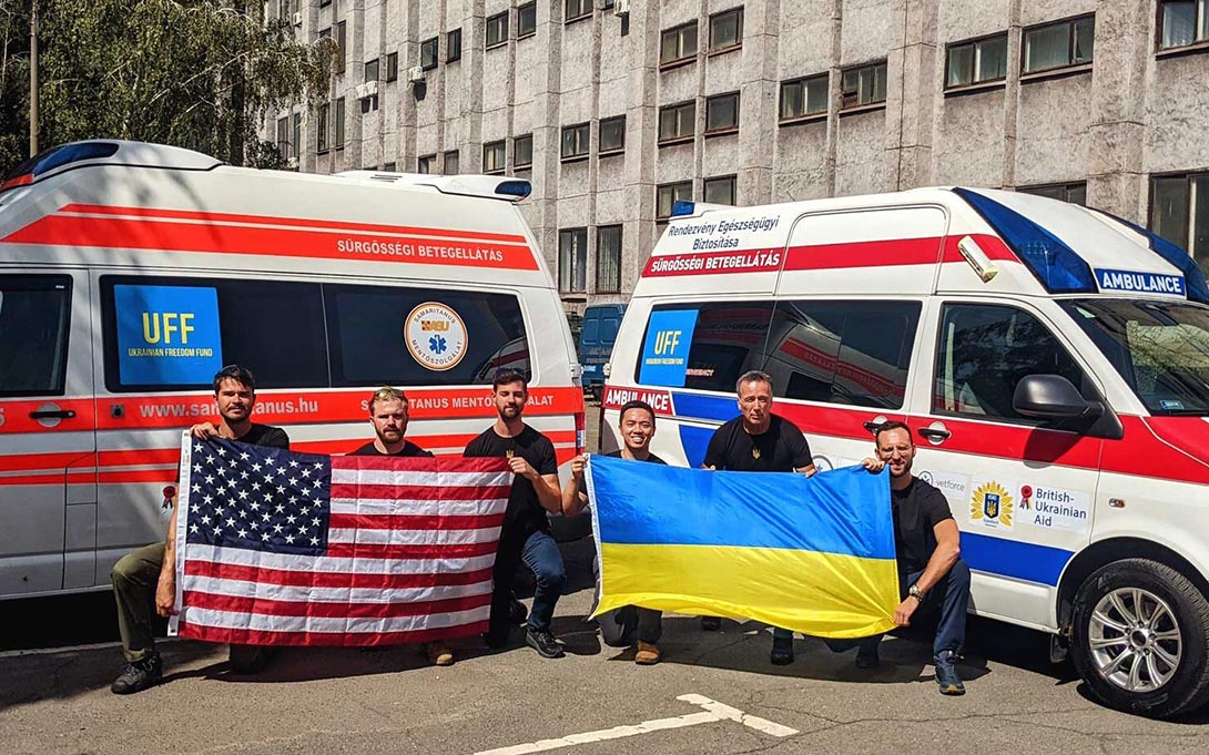 Photo of two groups of three holding an American flag on the left and a Ukrainian flag on the right